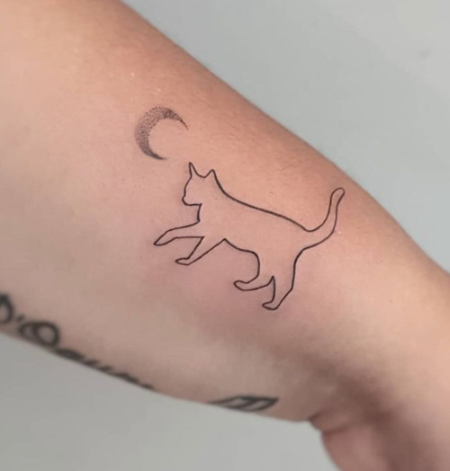 Minimalist cat tattoo on the wrist.