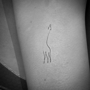 cute tiny giraffe tattoo