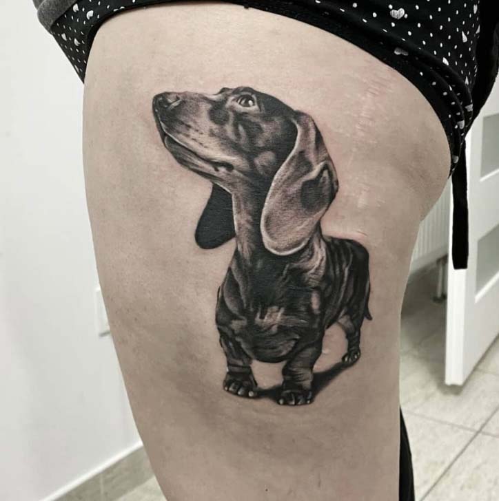 detailed black dachshund leg tattoo