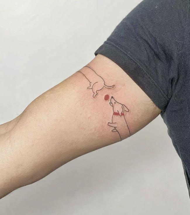 long wiener dog line tattoo on arm