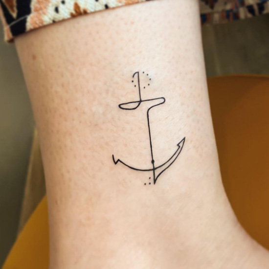 Minimalist anchor tattoo on the ankle