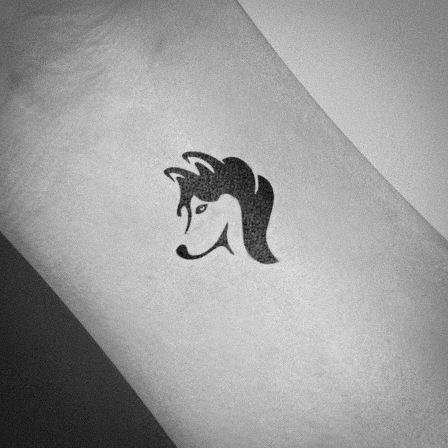 Small husky tattoo on the inner forearm