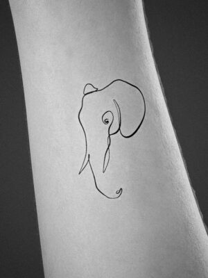 One line elephant tattoo located on the elbow,