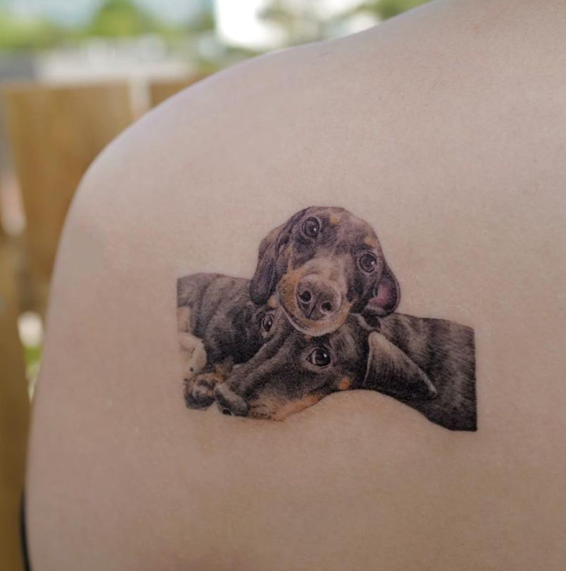 two wiener dog tattoo on shoulder