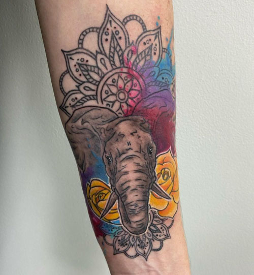 Watercolor elephant tattoo on the upper back