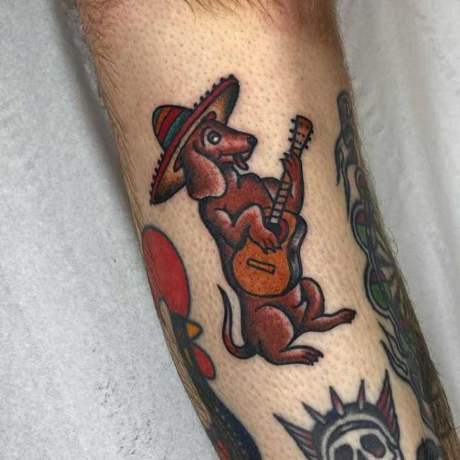 wiener dog with guitar and hat tattoo